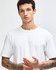 A white unisex short sleeve t-shirt displayed on a model paired with black leggings and white sneakers.