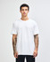 A woman wearing a plain white unisex short sleeve t-shirt. The t-shirt has a logo on it.