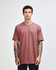 A unisex fine jersey short sleeve t-shirt in a pink colour, featuring a simple design and a logo on the front.