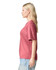 A side view of a woman wearing a rose pink unisex short sleeve T-shirt. The shirt has a simple design and a logo.