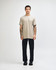 A model wearing an olive green unisex CVC short sleeve t-shirt and black cargo pants, featuring a logo.