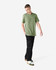 A model wearing a green unisex short sleeve T-shirt and black cargo pants, standing in a neutral setting.