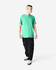 A unisex short sleeve t-shirt in vibrant green, paired with black cargo pants and styled on a male model.