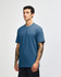 A unisex short sleeve T-shirt in a blue hue, featuring a simple design and a logo on the front.