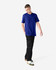 A unisex short sleeve t-shirt in blue, paired with black cargo pants, displayed on a model.
