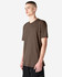 A unisex short sleeve T-shirt in brown, displayed on a model standing against a plain background. It features a logo.