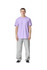 A model stands in a lavender unisex CVC short sleeve T-shirt paired with light grey trousers. The shirt has a logo.