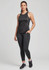 A woman wearing black Luna 7/8 length leggings and a matching tank top, standing confidently with one hand on her hip.