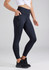 A pair of navy women's 7/8 length leggings with pockets, complete with a logo, worn with a white top and black shoes.