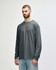 A dark navy long sleeve t-shirt is displayed on a model, featuring a logo on the sleeve.