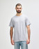 A grey T-shirt with a relaxed fit, featuring a logo on the front, displayed on a male model.