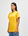 A model wearing a bright yellow Gildan Heavy Cotton adult T-shirt, standing against a plain background.