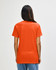 An orange Gildan Heavy Cotton adult t-shirt displayed from the back, featuring a simple design and a logo.
