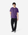 A purple Gildan Heavy Cotton Adult T-Shirt displayed on a model, paired with black jeans and casual shoes.