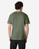 A man wearing a plain olive green Gildan Heavy Cotton Adult T-Shirt, viewed from the back. The shirt has a logo.