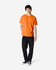 An orange Gildan Heavy Cotton adult T-shirt worn by a standing male model, paired with black jeans and sneakers.