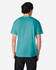 A man wearing a turquoise Gildan Heavy Cotton Adult T-Shirt, viewed from the back. The shirt has a logo.