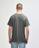 A grey Gildan Heavy Cotton adult t-shirt viewed from the back, featuring a simple design and short sleeves.