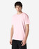 A pink Gildan Heavy Cotton Adult T-Shirt displayed on a model, featuring short sleeves and a relaxed fit.
