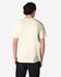 A plain cream adult t-shirt is displayed from the back, showcasing its simple design and fabric texture.