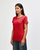 A red Gildan Heavy Cotton Ladies' T-Shirt displayed on a model, featuring a classic fit and short sleeves.