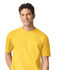 A man wearing a bright yellow Gildan Softstyle adult T-shirt, featuring a round neckline and short sleeves.
