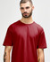 A red Gildan Softstyle adult t-shirt worn by a model, featuring a crew neckline and short sleeves.