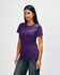 A Gildan Softstyle ladies' T-shirt in purple, featured on a model, displayed from the side with casual jeans.