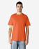 An orange midweight T-shirt for adults, displayed on a model with a neutral background. Features a logo.