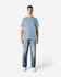 A light blue Gildan Softstyle adult midweight T-shirt displayed on a male model wearing light jeans.