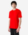 A red midweight t-shirt on a model, featuring a simple design and a logo on the shirt.