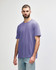 A purple Gildan Softstyle adult midweight T-shirt on a model, featuring a simple design and short sleeves.