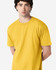 A yellow Gildan Softstyle adult midweight t-shirt on a model, featuring short sleeves and a casual fit.