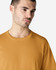 A midweight adult t-shirt in a mustard yellow colour, featuring a crew neck and short sleeves. It has a logo.