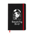 A black A5 notebook featuring a graphic design on the cover, secured with a red elastic band.