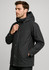 A black men's jacket with a hood, featuring a front zip and snap closure, and side pockets.