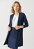 A longline cardigan in navy, featuring an open front and long sleeves, paired with a blouse and skirt.