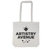 A tote bag with a long handle featuring the text "ARTISTRY AVENUE" and decorative floral elements.