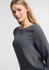 A grey women's boatneck top with long sleeves displayed on a model against a neutral background.