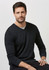 A black Merino pullover sweater is displayed being worn by a man, featuring a V-neck and long sleeves.
