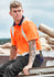 An orange short sleeve polo shirt with shoulder tape detail, worn by a tattooed man sitting outdoors.