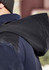 A waterproof jacket in navy blue with a dark hood, featuring a logo on the back.