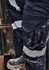 A pair of navy work pants featuring cooling stretch material and striped taping details. They have multiple pockets and a logo.