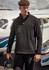 A black lightweight 1/4 zip polar fleece is worn by a model near a small aircraft, featuring a zip pocket and branding.