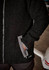 A black unisex full zip sherpa fleece jumper with side pockets and a logo.