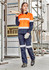 A woman in an orange and navy long sleeve industrial shirt, holding timber, wears work gloves and sturdy boots.