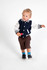 A toddlers' varsity jacket in navy blue and white, featuring striped cuffs, paired with brown shorts and playful socks.