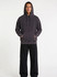 A men's stone wash fleece hoodie in a dark blue hue, featuring a hood and a relaxed fit, with a logo on the front.