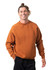 An adult wearing a rust-coloured cotton sweatshirt, featuring a relaxed fit and a simple design.