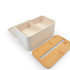 A cream-colored lunch box with a bamboo lid and divided interior, designed for eco-friendly use.
